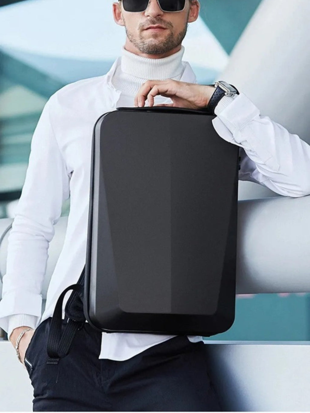 LAVIZAR black hard shell anti-theft laptop backpack held by business traveler