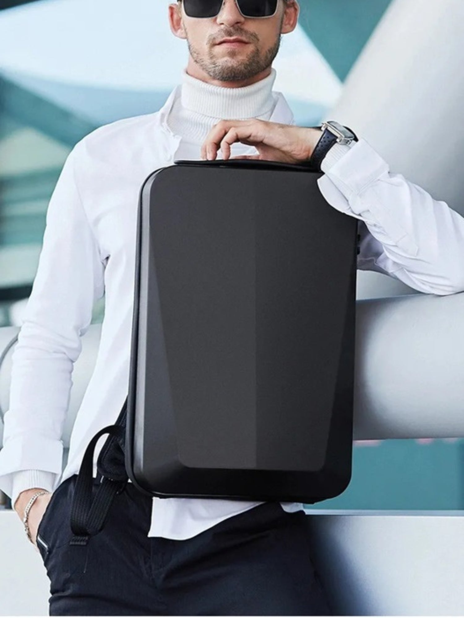 LAVIZAR black hard shell anti-theft laptop backpack held by business traveler