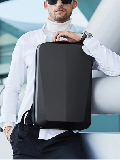 LAVIZAR black hard shell anti-theft laptop backpack held by business traveler