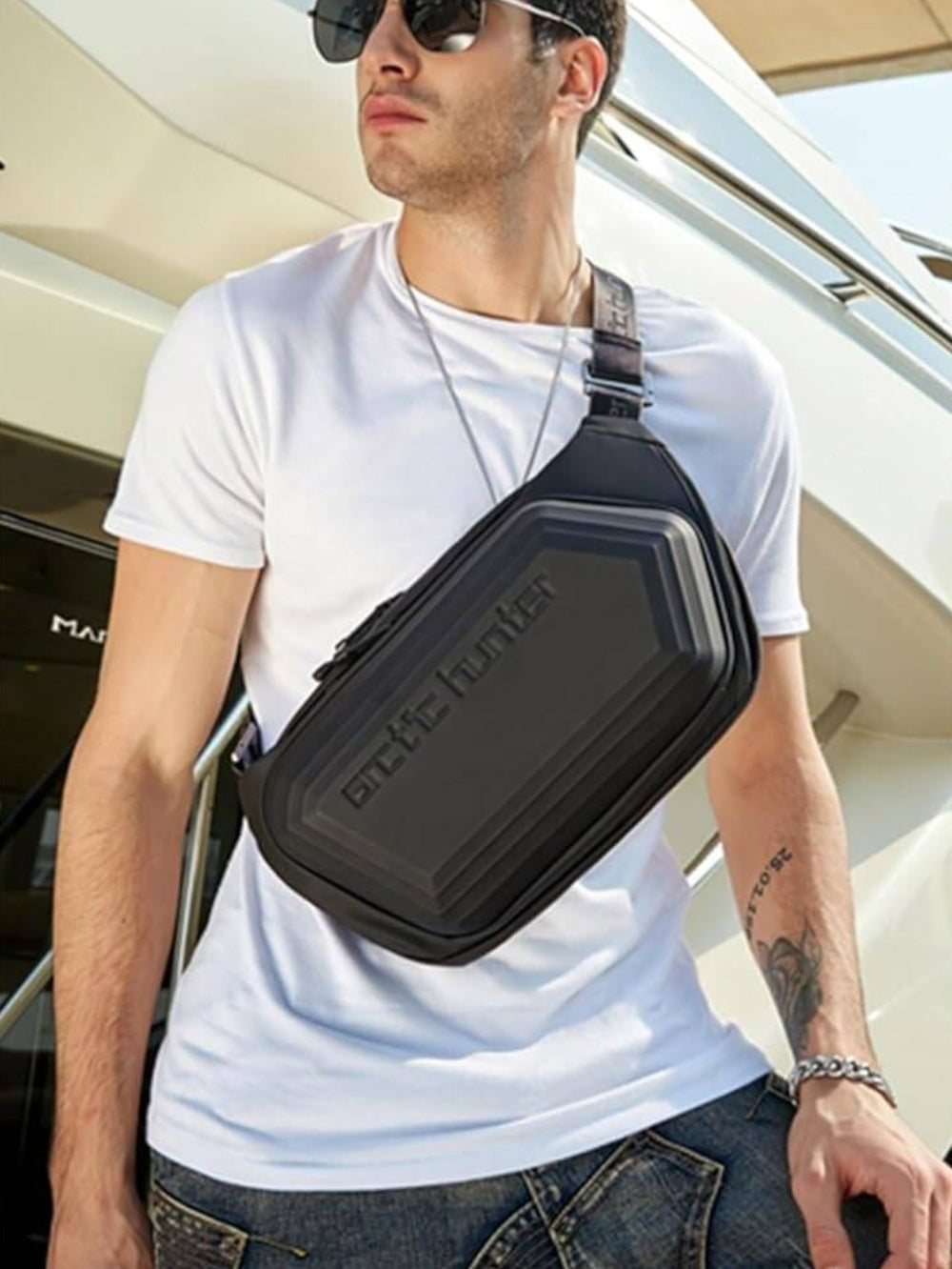 Arctic Hunter hard-shell waterproof crossbody chest bag worn by male model lifestyle view