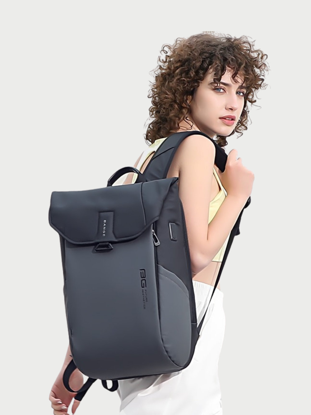 Female model carrying Bange 2575 grey anti-theft laptop backpack lifestyle view