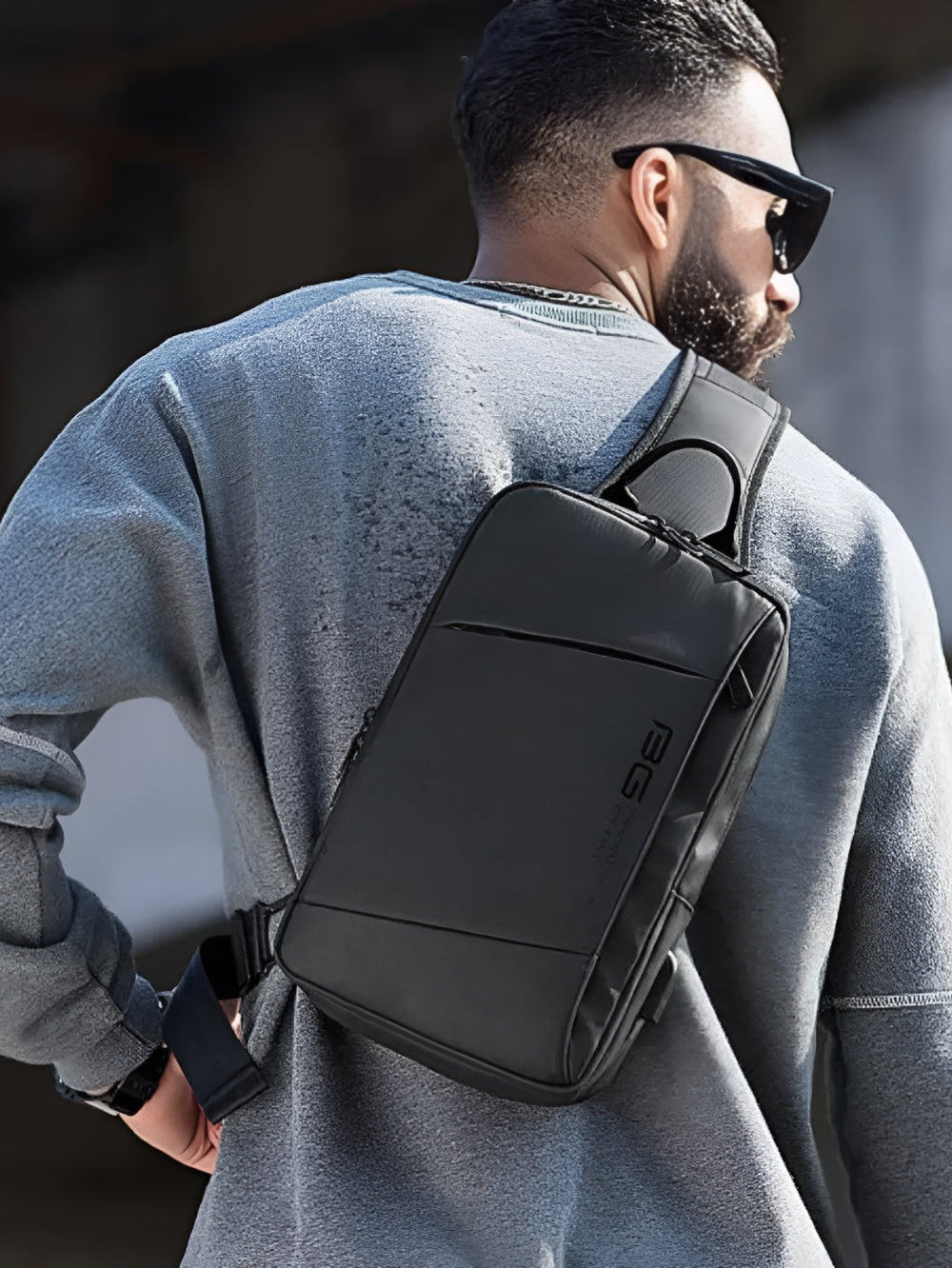 Bange BG-22002 water resistant crossbody sling bag worn on back by male model lifestyle view