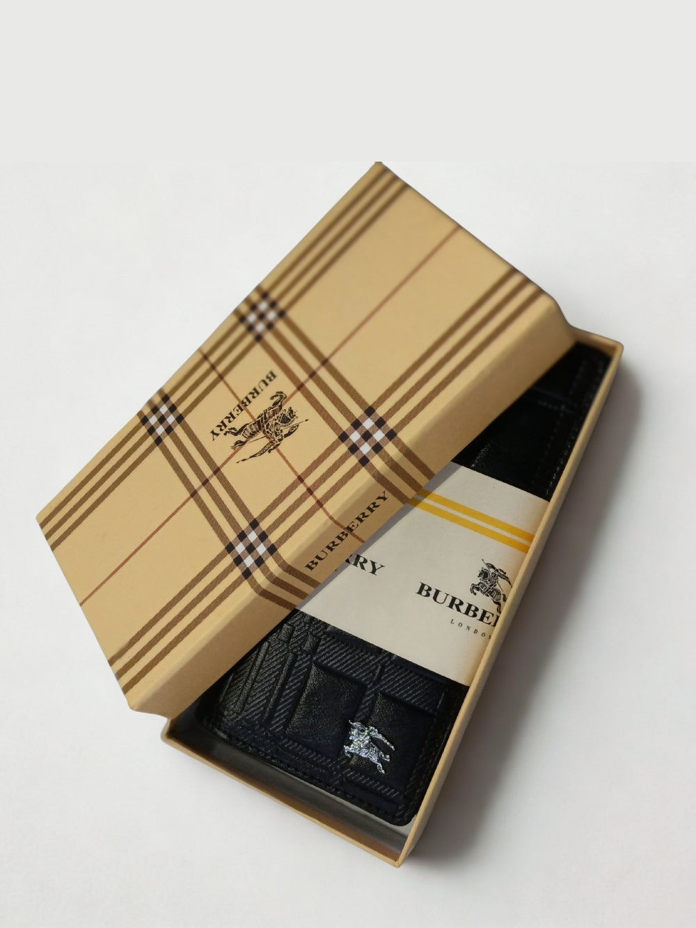 Black embossed leather long wallet presented in a beige gift box