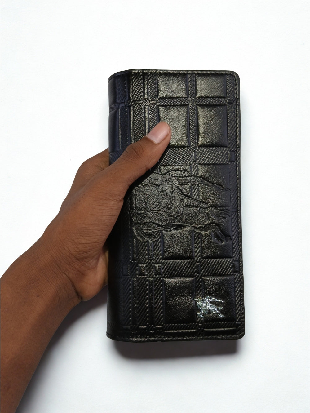 Hand holding black embossed check pattern leather long wallet
