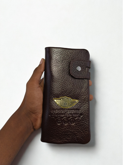Hand holding dark brown Esiposs pebbled leather long men's trifold clutch wallet