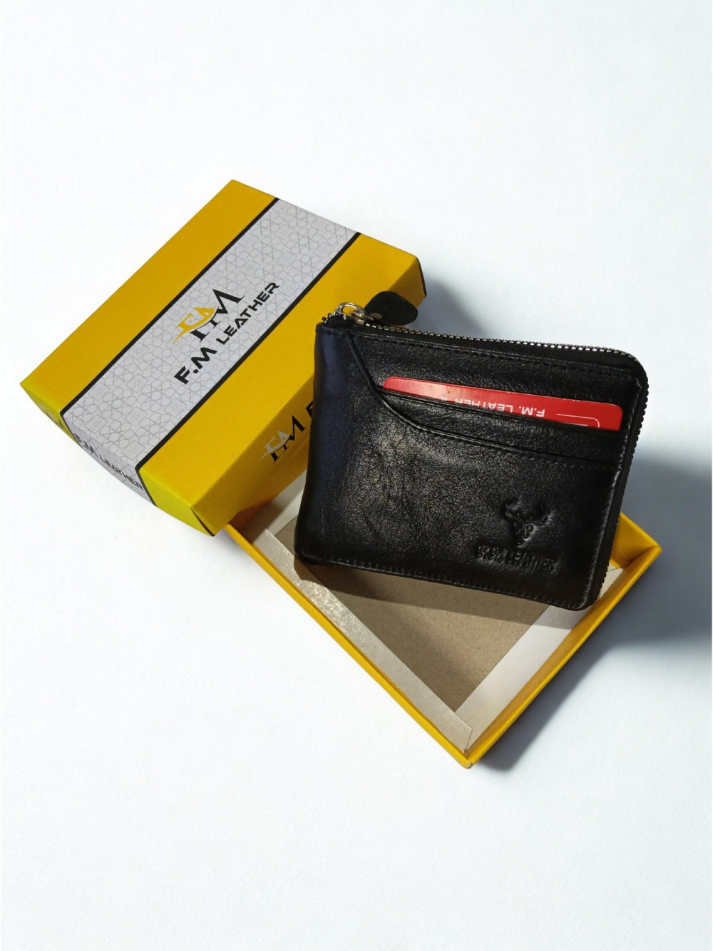 Full grain black leather zipper bifold wallet placed on yellow F.M. Leather packaging box