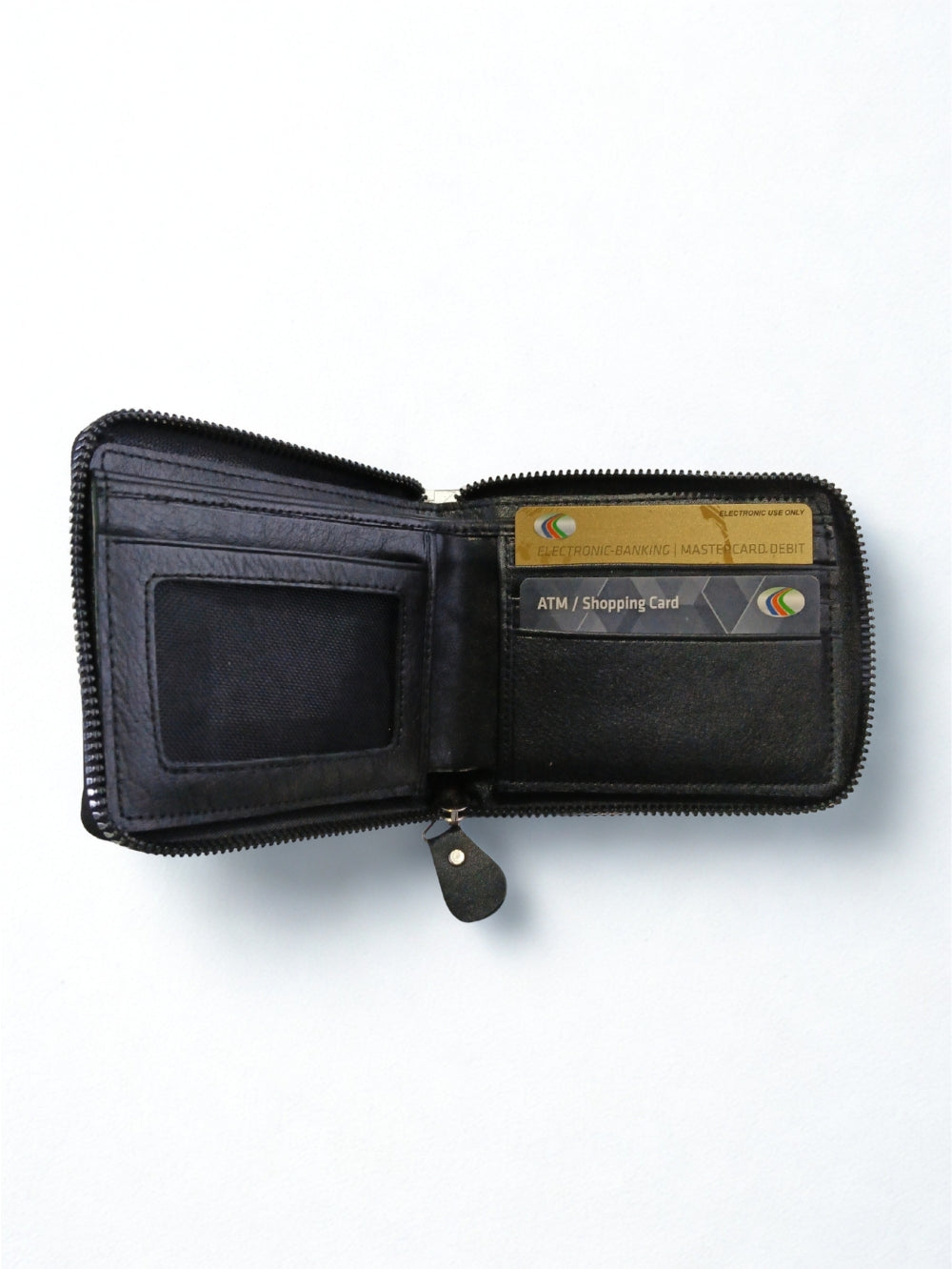Open interior view of black leather zip-around wallet displaying card slots and ID window