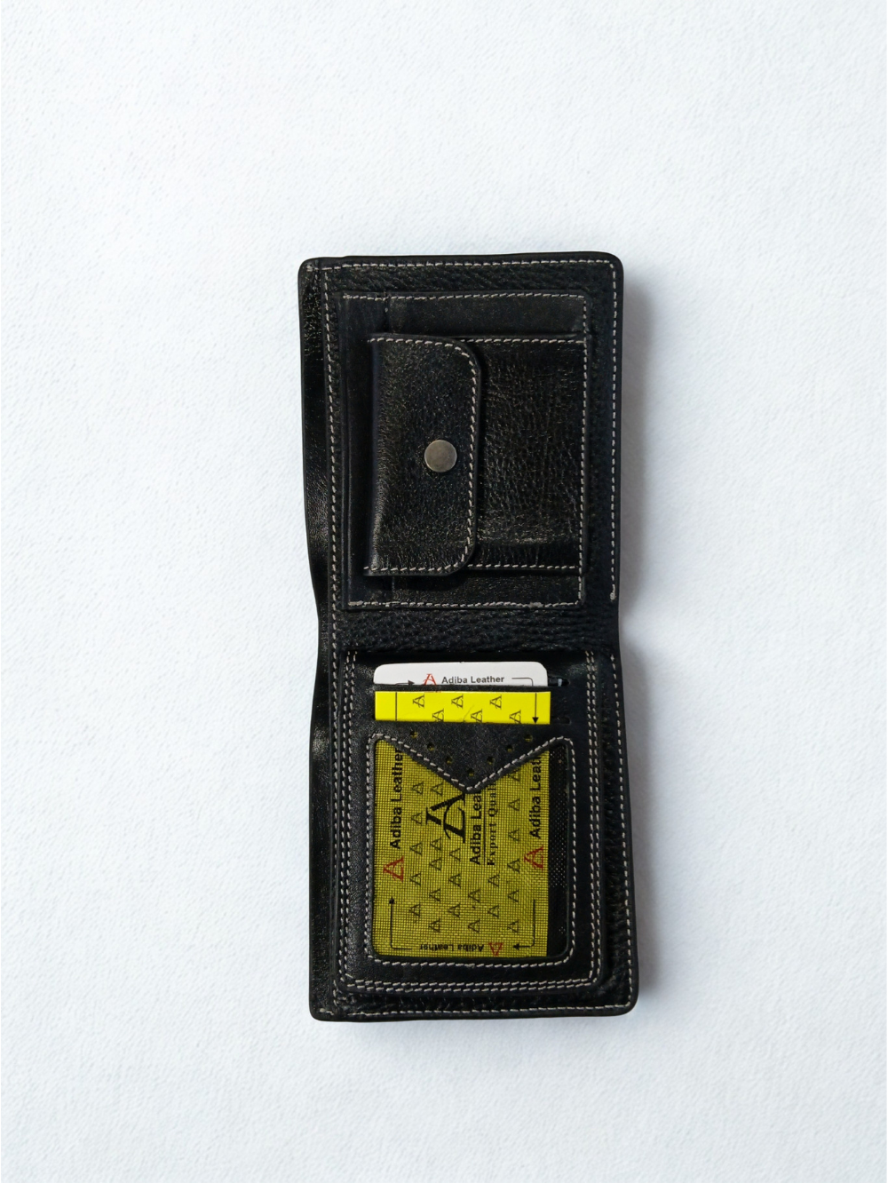 Open interior view of black leather wallet showing snap coin pocket, card slots, and ID window