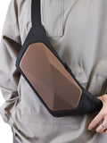 brown hard shell geometric rhombus chest sling bag worn by model