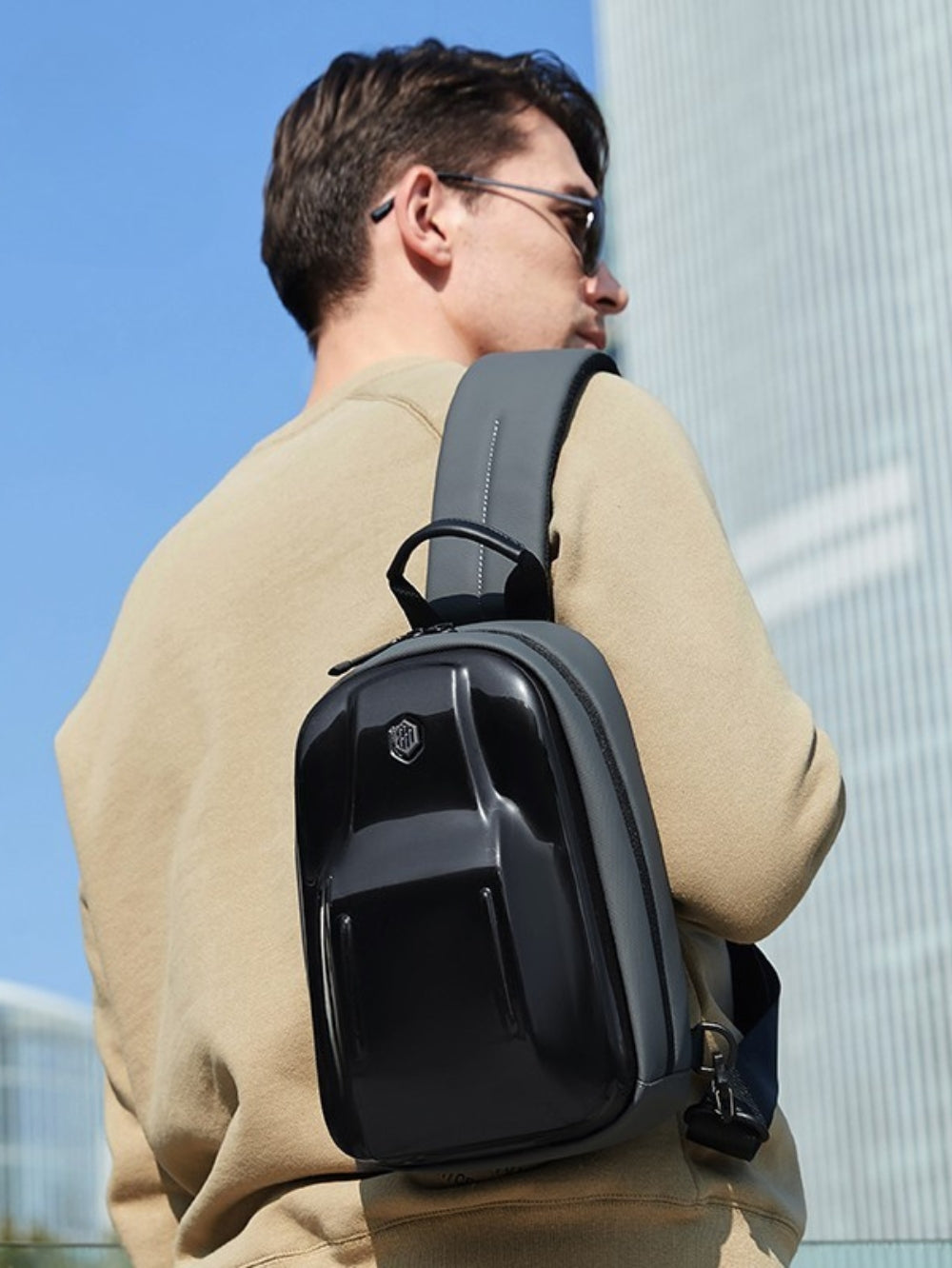 LAVIZAR hard shell cross body sling bag worn by male model lifestyle view