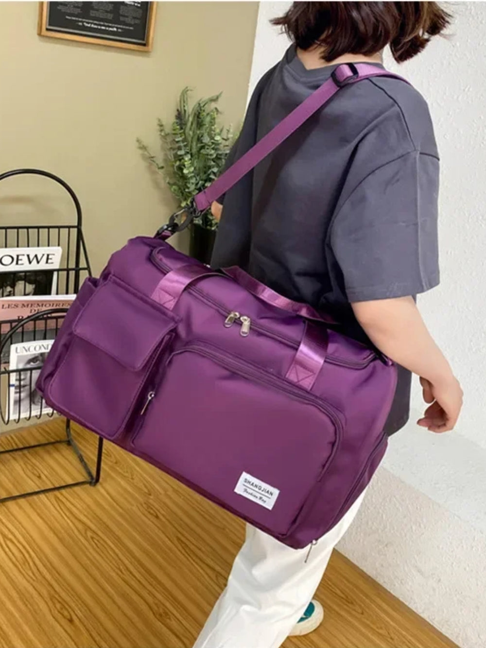 LAVIZAR purple travel and gym duffle bag carried over shoulder lifestyle view