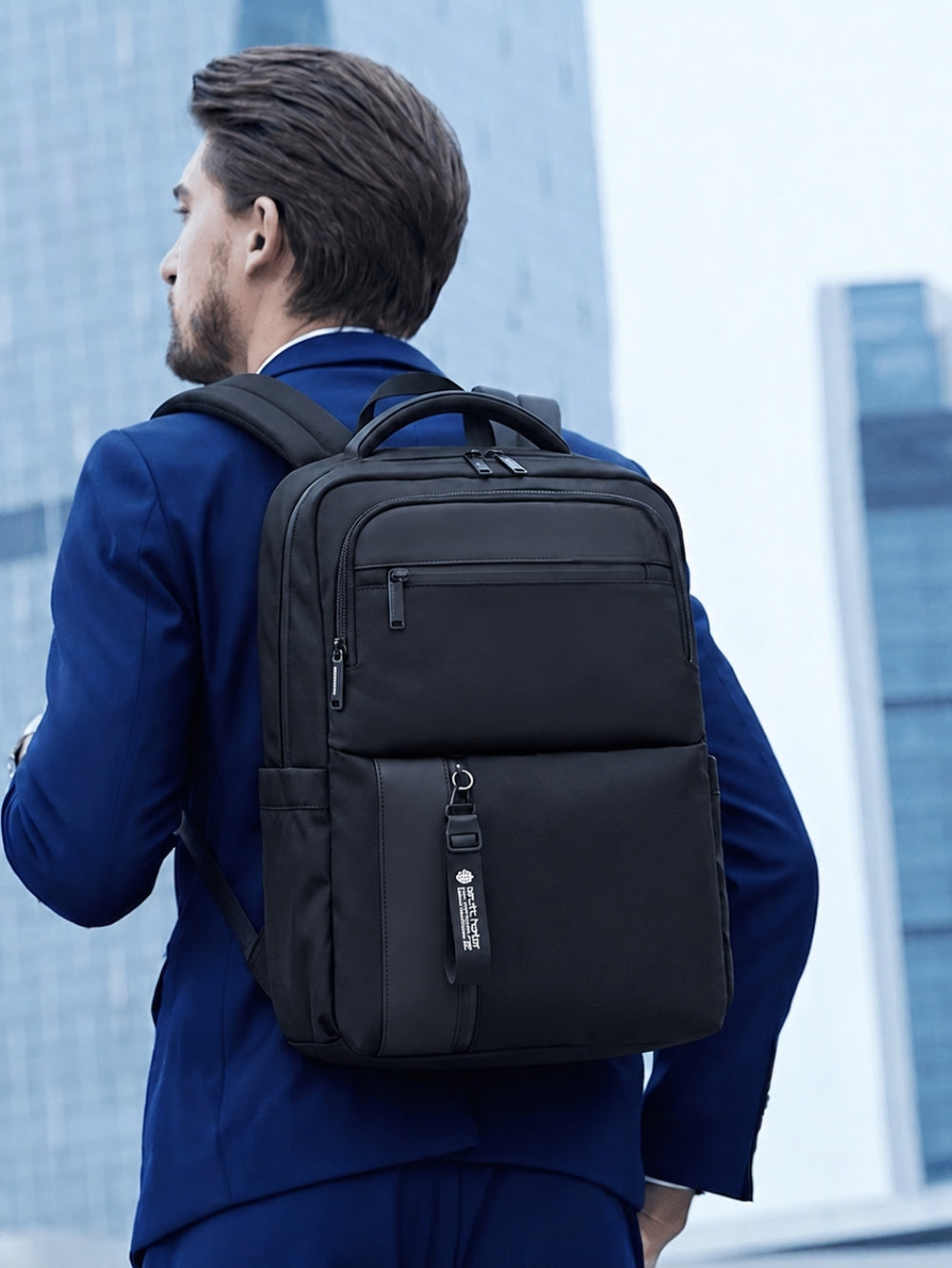 LAVIZAR black waterproof anti theft laptop backpack worn by businessman in suit