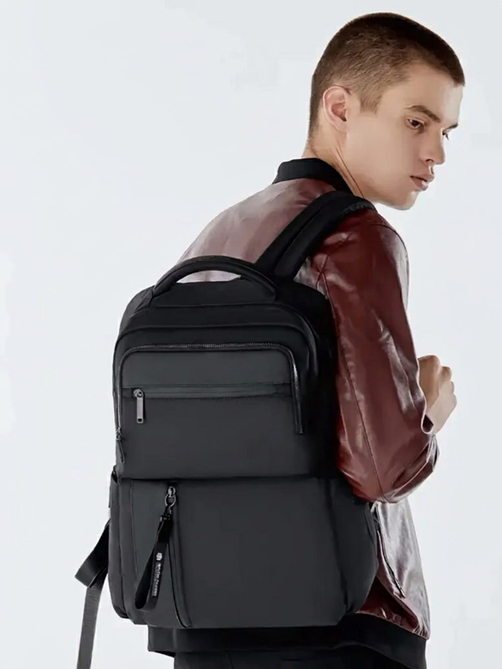black waterproof anti theft laptop backpack worn by travel man 