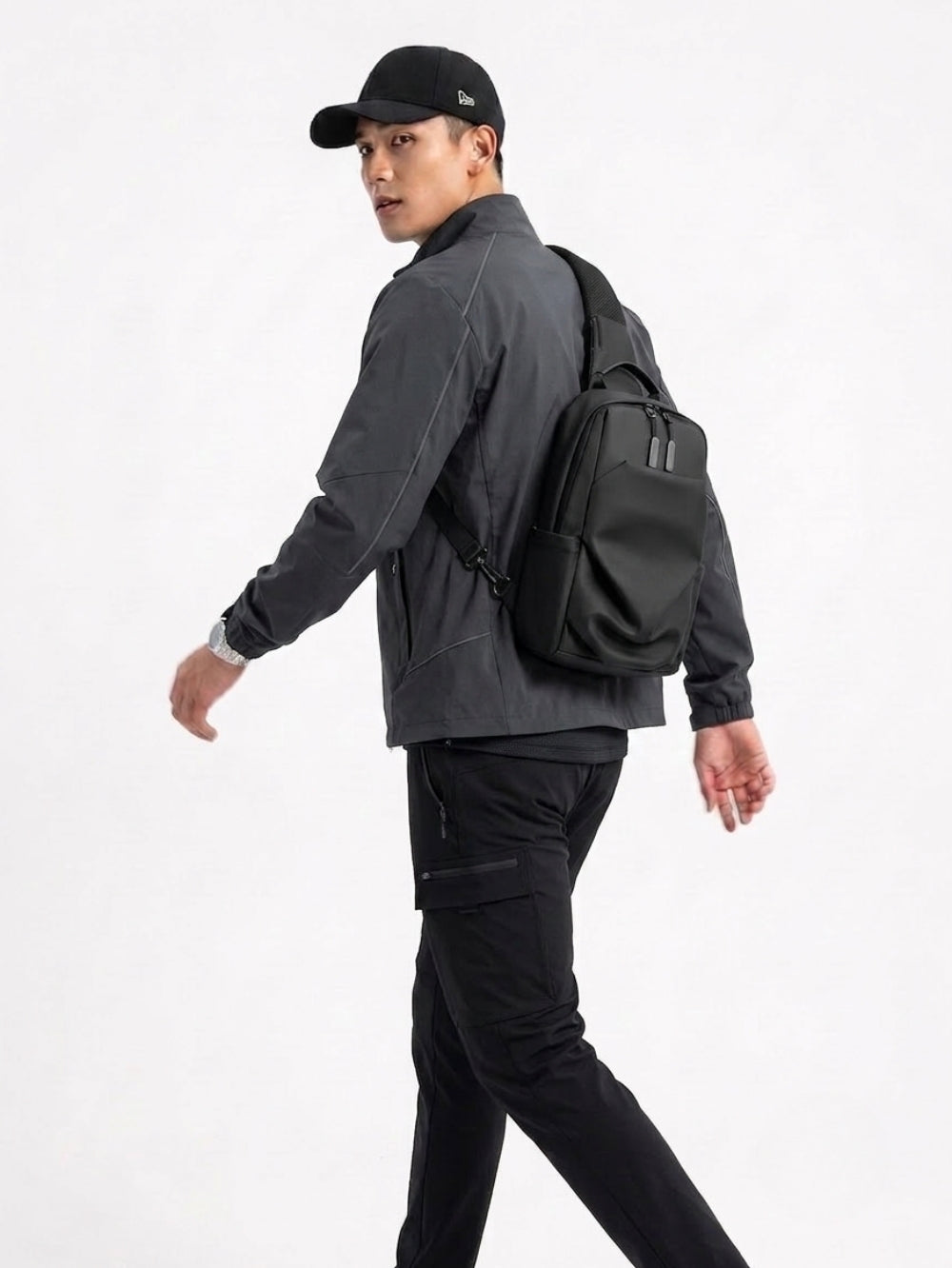 LAVIZAR black waterproof crossbody sling bag worn by male model lifestyle shot