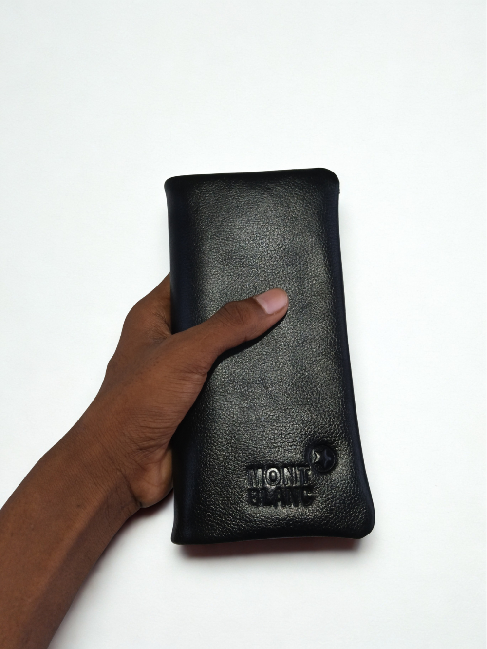 Hand holding black genuine pebbled leather men long wallet