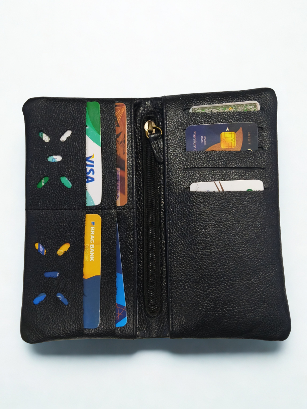 Open interior view of black leather long wallet showing card slots and central zipper pocket
