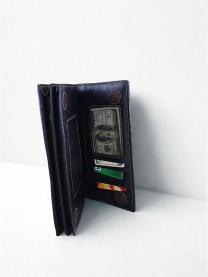Side angle view of open black pebbled leather long wallet showing multi-layer compartments